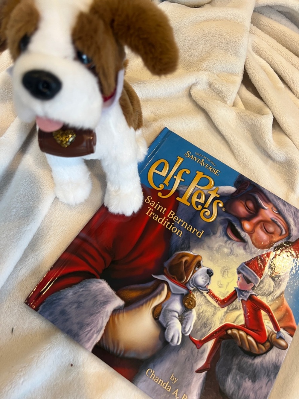 Elf on the shelf Pets Saint Bernard with his adorable story book.